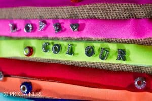 Lycra ribbons in bright, fluorescent colours with studded metal letters spelling 'Love Colour'. Photo by Piccia Neri, all rights reserved.