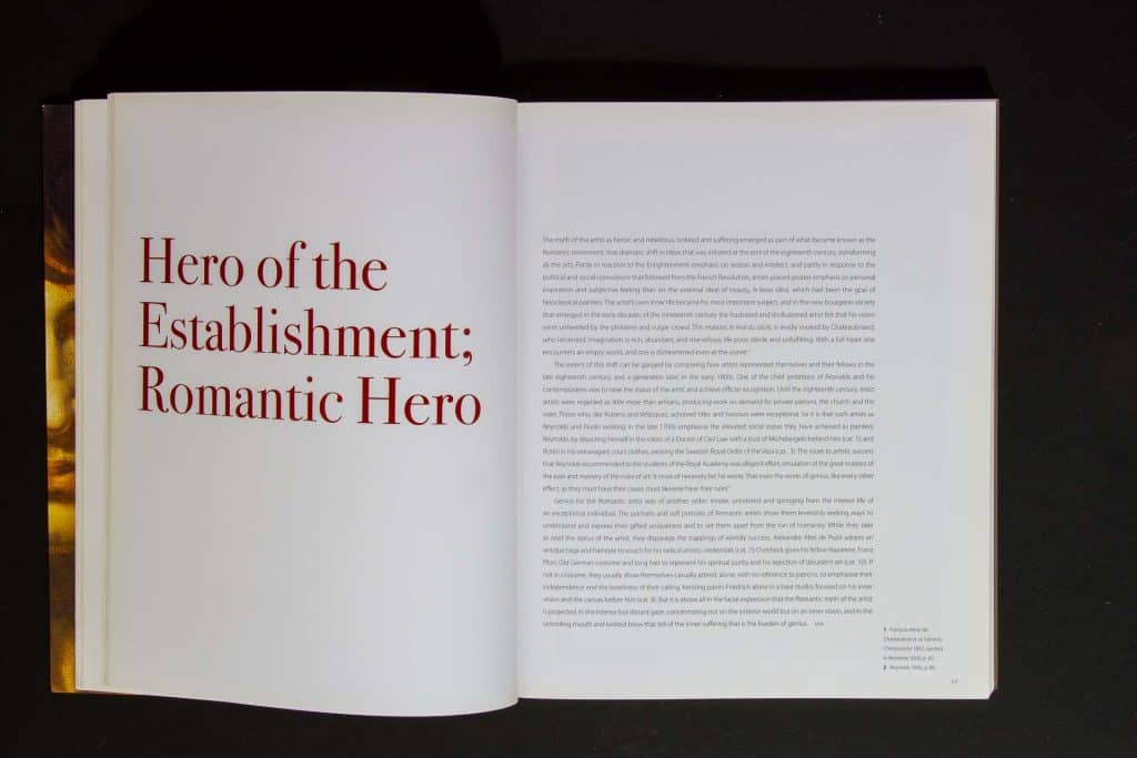 Full opening spread of the essay Hero of the Establishment; Romantic Hero, in the National Gallery exhibition catalogue Rebels and Martyrs. The title is in very big, bold red Didot typeface occupying half of the page on the left, with the text starting on the right page